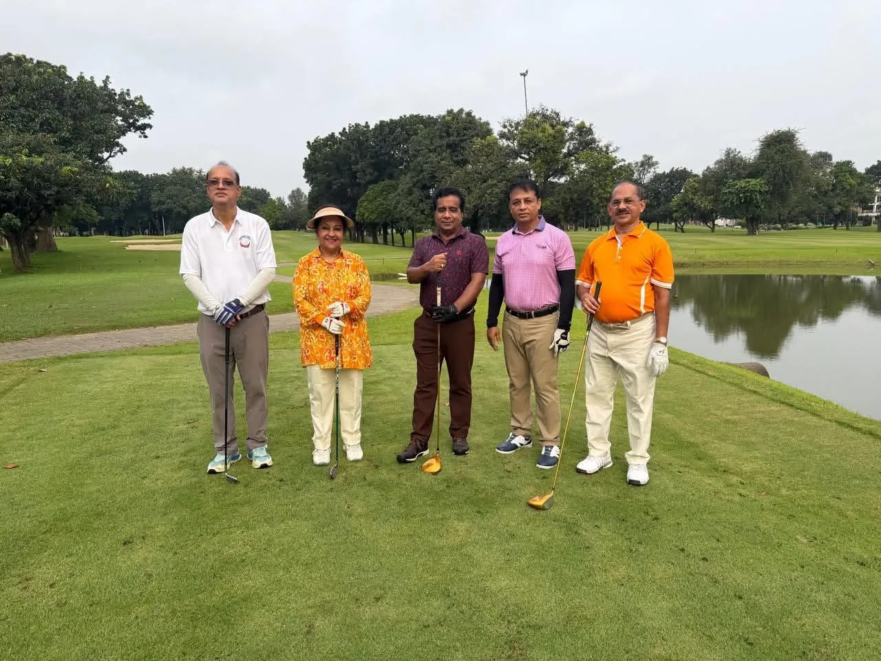 Players beside the water on the back nine